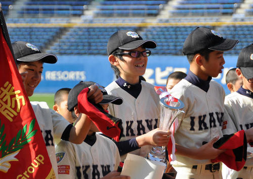 QVCマリンで行われたリアスリーグで優勝しトロフィーを手に笑顔の猪川小6年時の佐々木（中央）（リアスリーグ実行委員会提供）