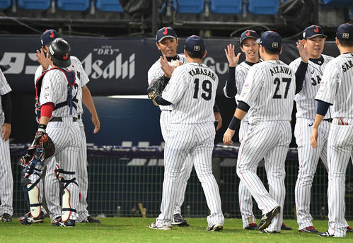 日本対ベネズエラ　逆転勝ちした稲葉監督（中央）は山崎から勝利球を渡される（撮影・山崎安昭）