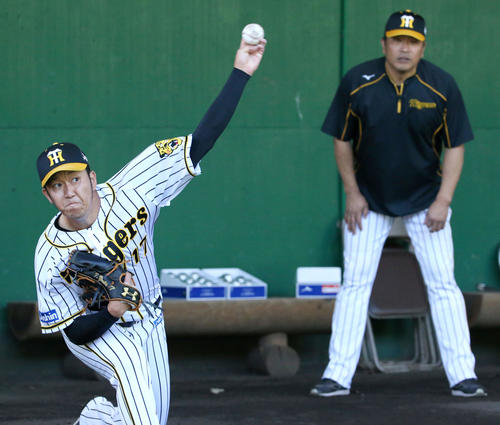 山本昌臨時コーチ（右）が見守る中投球する阪神岩貞（撮影・上山淳一）