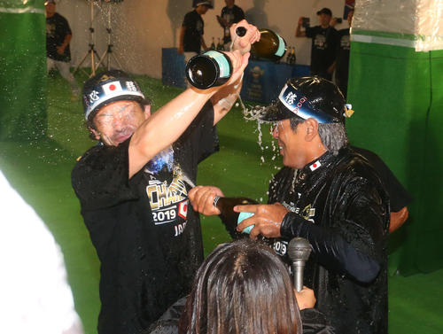 祝勝会で松田宣（左）にシャンパンをかける稲葉監督（撮影・山崎安昭）