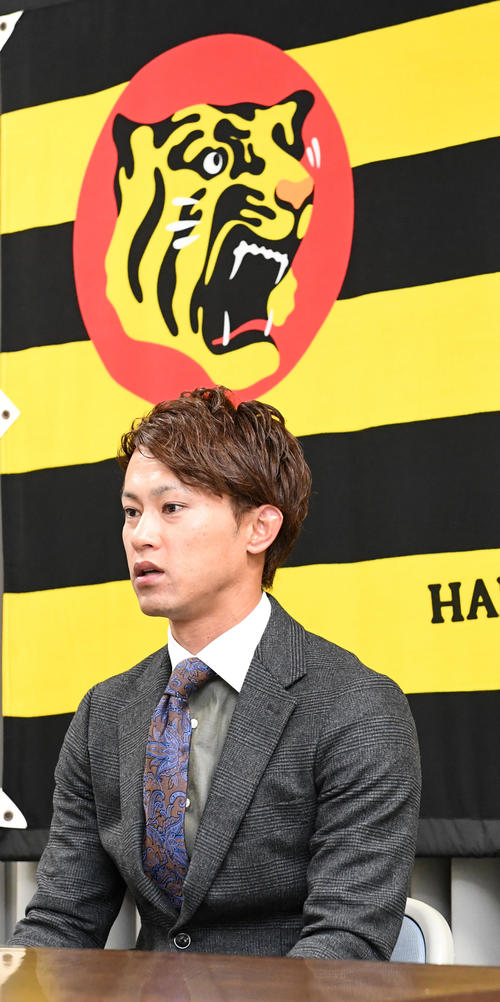 ダウンで契約を更改、厳しい表情で会見する上本（撮影・前岡正明）