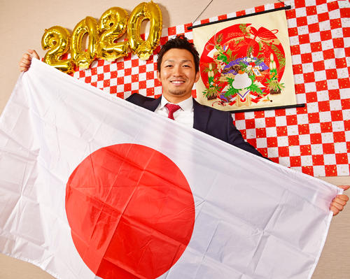 日の丸を手に笑顔をみせる広島鈴木誠也（撮影・清水貴仁）