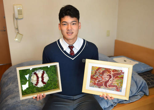 激励会で送られた絵画（右）などを手に入寮した中日石川昂（撮影・森本幸一）