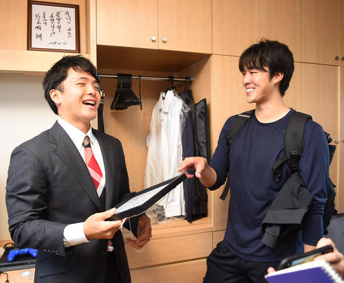 梅津晃大（右）とbacknumberの色紙を手に談笑する郡司裕也（左）（撮影・森本幸一）
