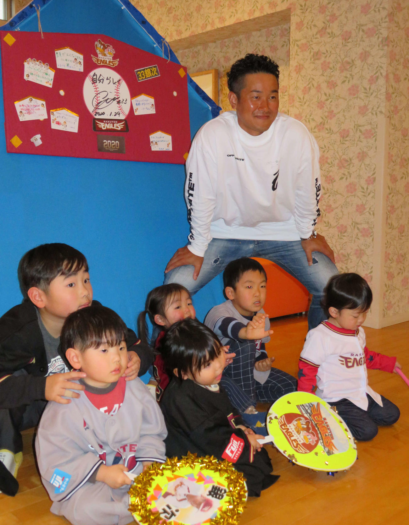 子供たちと一緒に書いた絵馬の前で写真に納まる楽天銀次