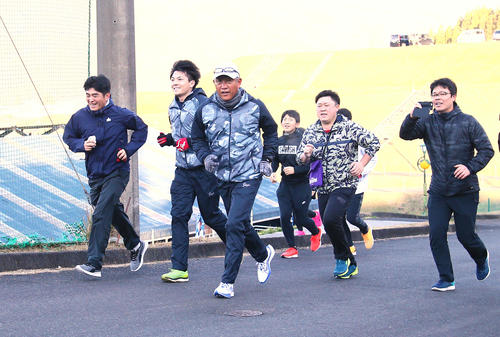 報道陣と早朝ランニングする西武辻監督（左から3人目）（撮影・足立雅史）