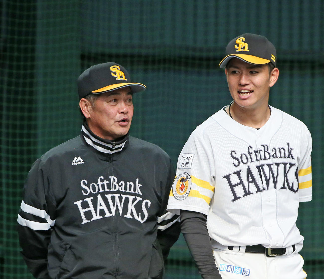 工藤監督（左）からアドバイスを受ける高橋礼（撮影・栗木一考）