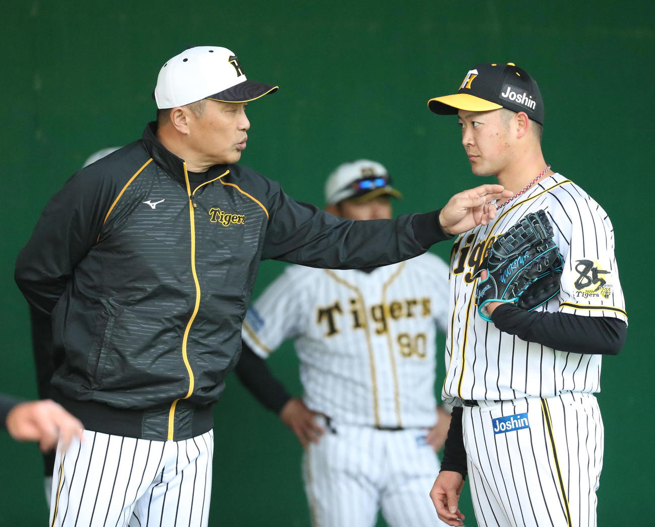 ブルペンで山本昌臨時投手コーチ（左）から指導を受ける斎藤（撮影・清水貴仁）