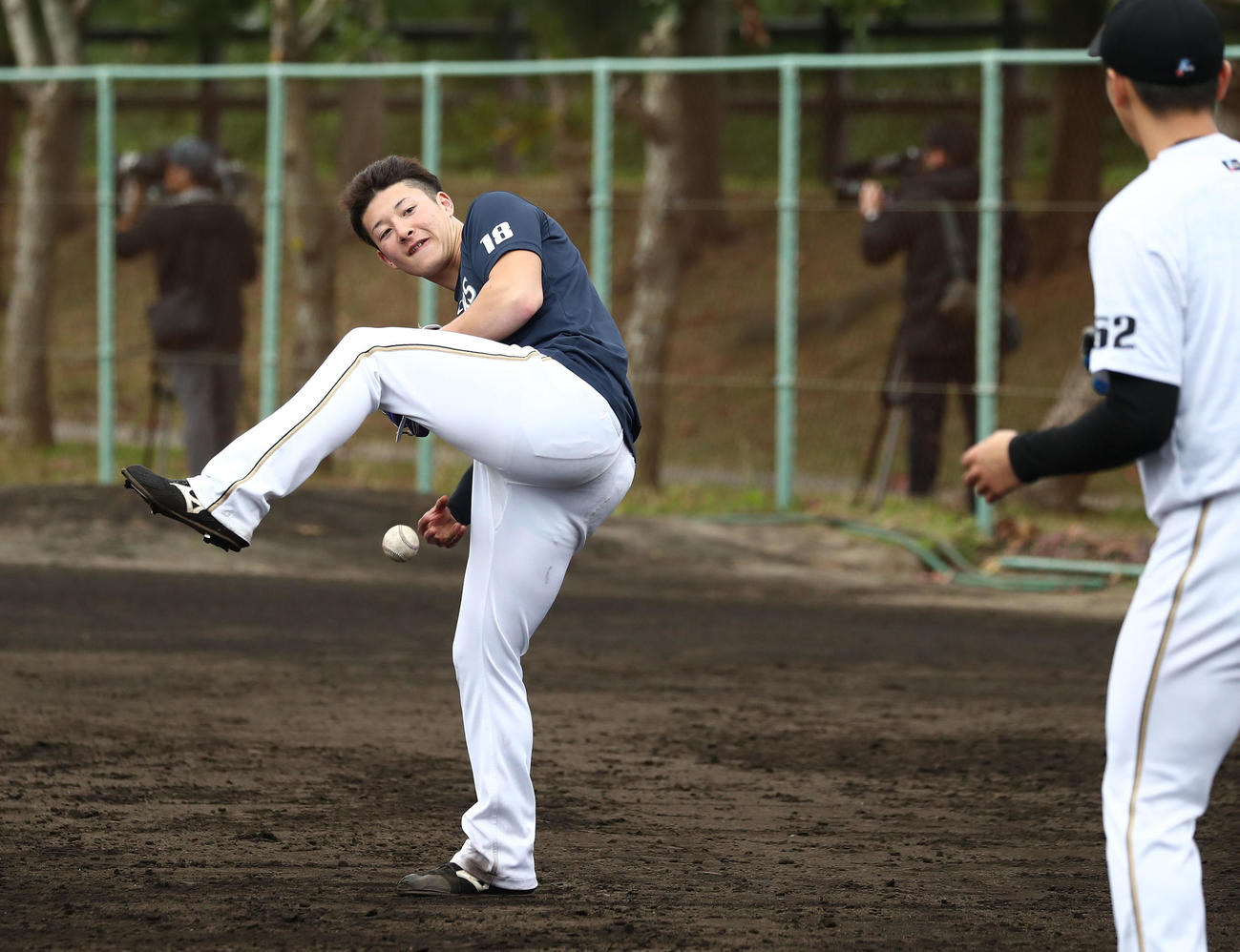 又の下から球を投げキャッチボールする日本ハム吉田輝（撮影・黒川智章）