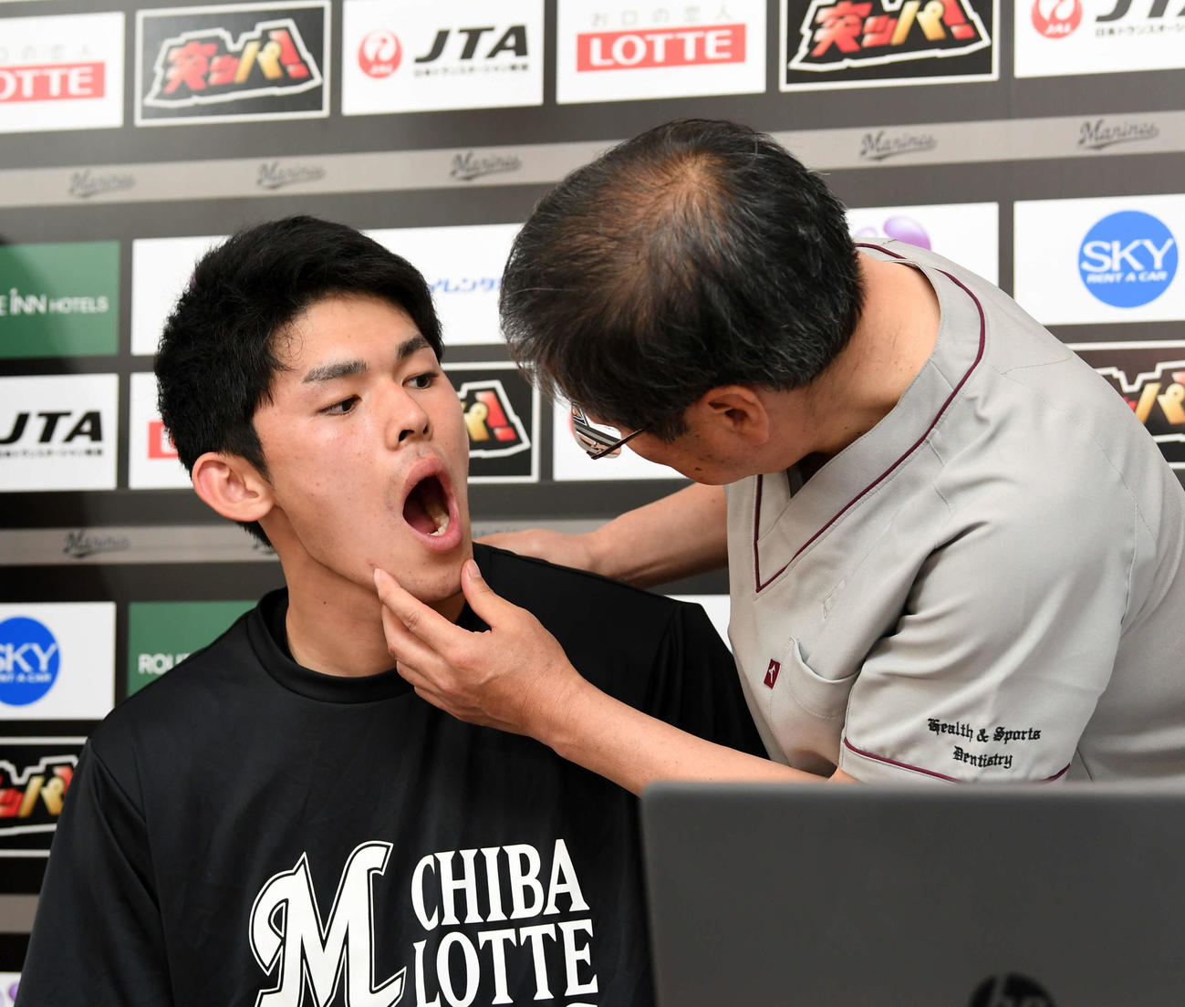 武田友孝教授（右）にかみ合わせチェックを受けるロッテ佐々木朗（撮影・横山健太）