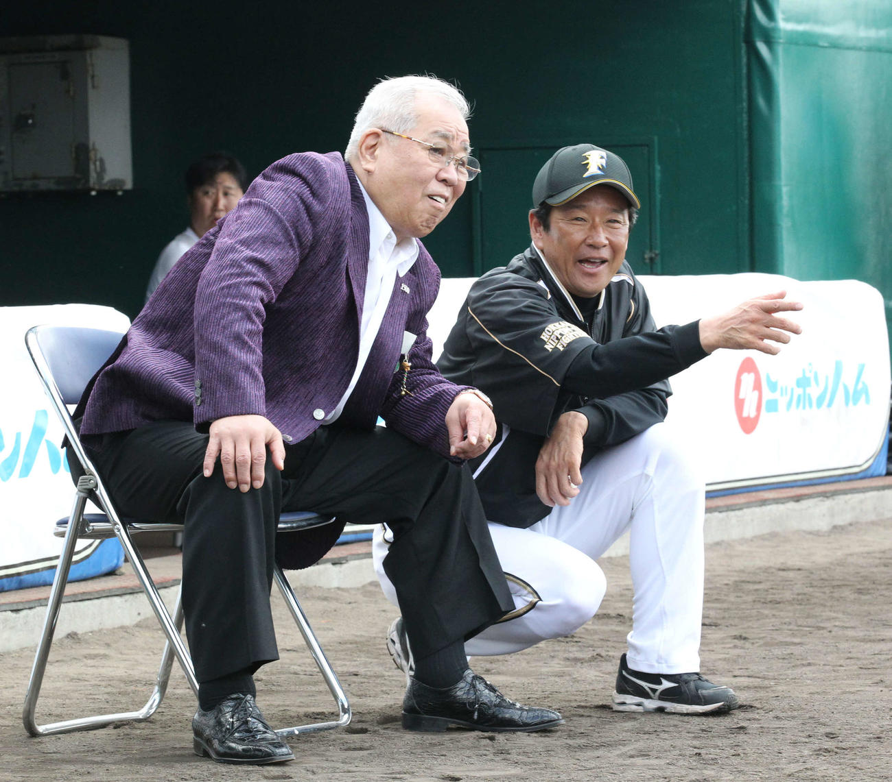 12年に日本ハムのキャンプ視察に訪れた野村氏（中央）と談笑する栗山監督
