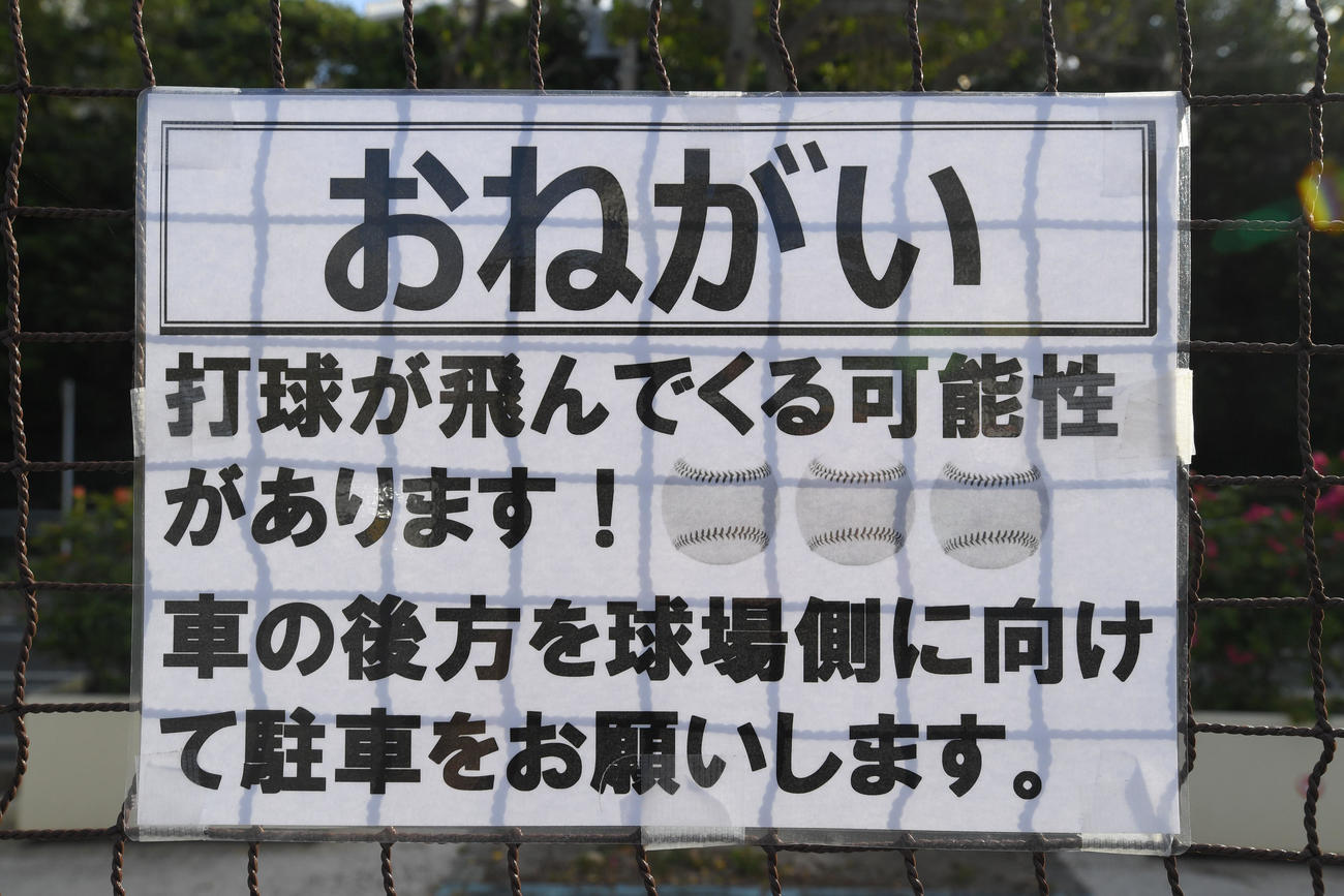 沖縄セルラースタジアム那覇の右翼席場外にある駐車場では、場外弾の注意喚起のため車の駐車方向に関する「おねがい」が掲示されていた（撮影・加藤諒）