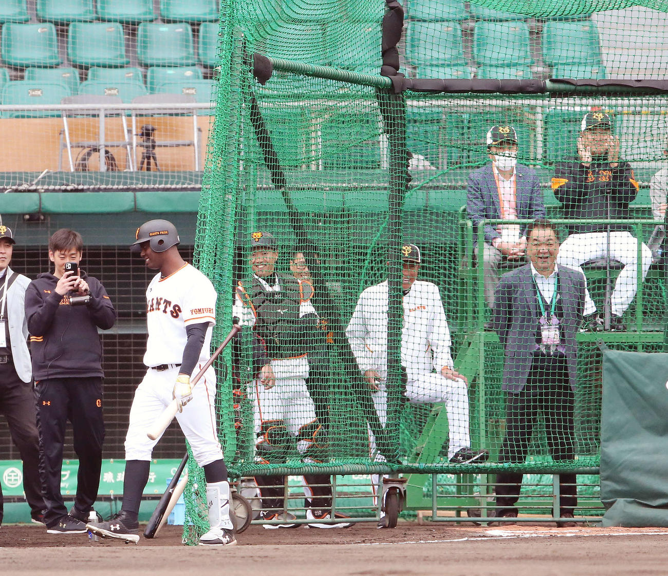 フリー打撃で巨人菅野から左中間に本塁打を放ったモタ（左手前）に拍手する原監督（後方右）（撮影・河野匠）