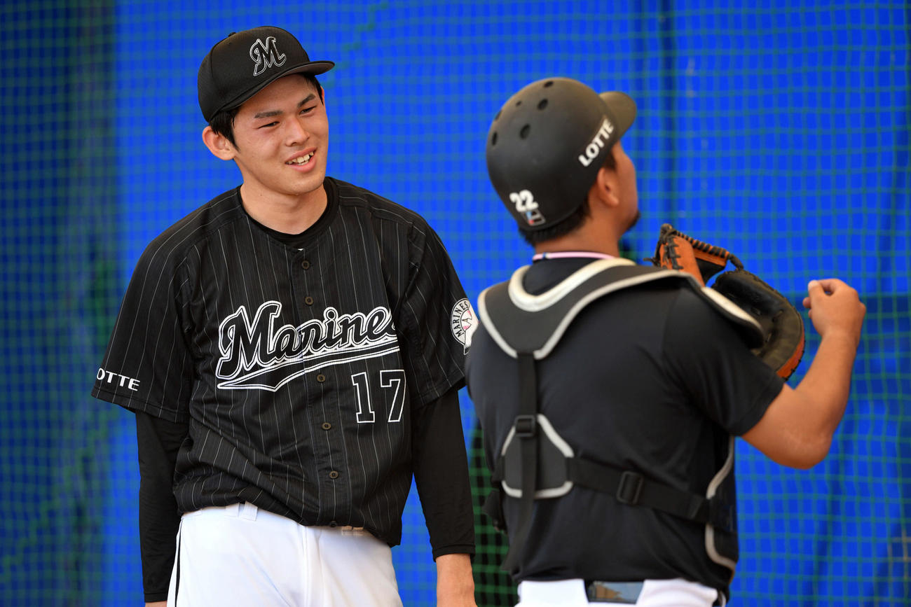 ブルペンでロッテ田村（手前）と話す佐々木朗（撮影・滝沢徹郎）