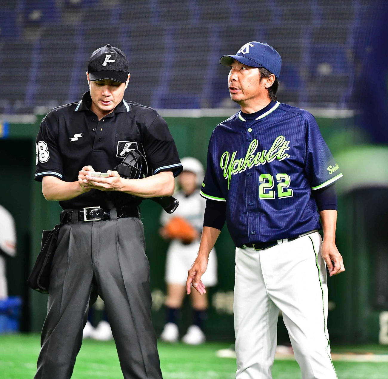 巨人対ヤクルト　牧田球審（左）に選手交代を告げるヤクルト高津監督（撮影・小沢裕）