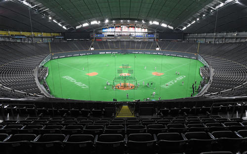 試合開始前、通常であれば観客が入場する午後4時を過ぎても空席のままの札幌ドームで練習をする巨人ナイン（撮影・加藤諒）