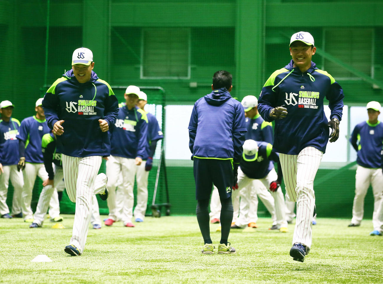 ウオーミングアップ中、笑顔を見せるヤクルトの村上（左）と奥川（撮影・足立雅史）