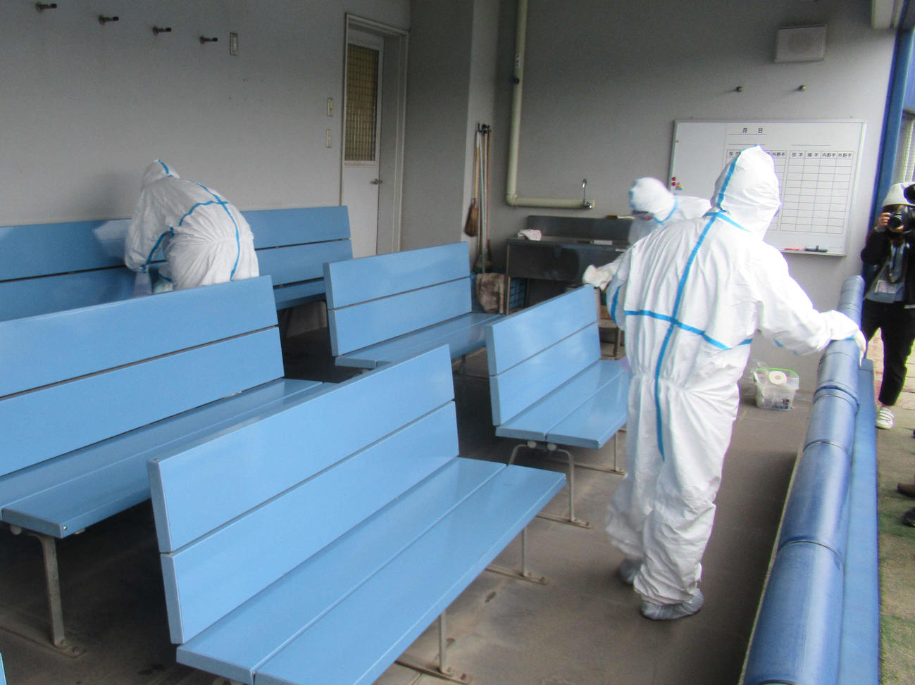 清掃業者が防護服に身を包んでナゴヤ球場一塁側ベンチを消毒（撮影・伊東大介）