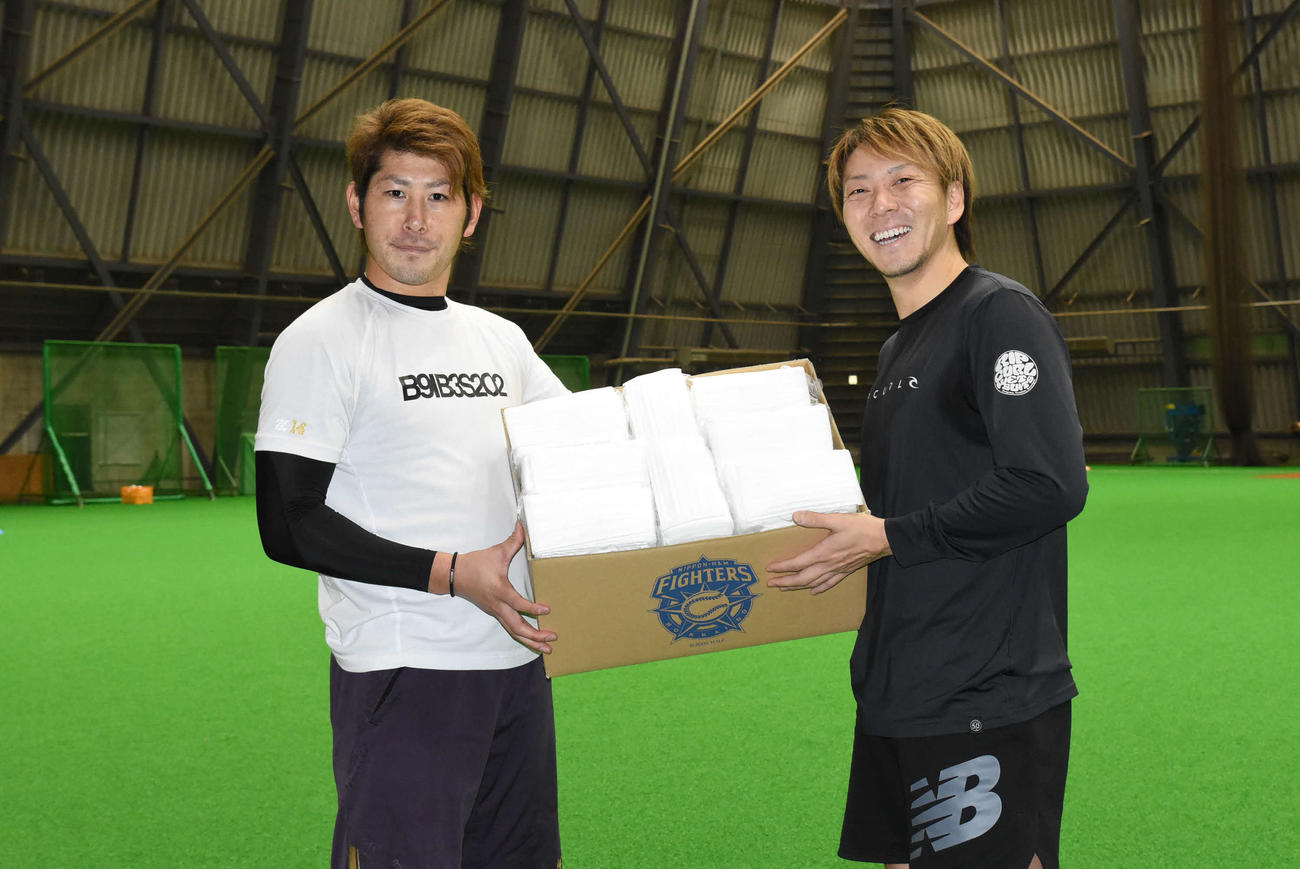 マスクが入った箱を持つ日本ハム宮西（右）と加藤の両投手（球団提供、マスクはイメージ）