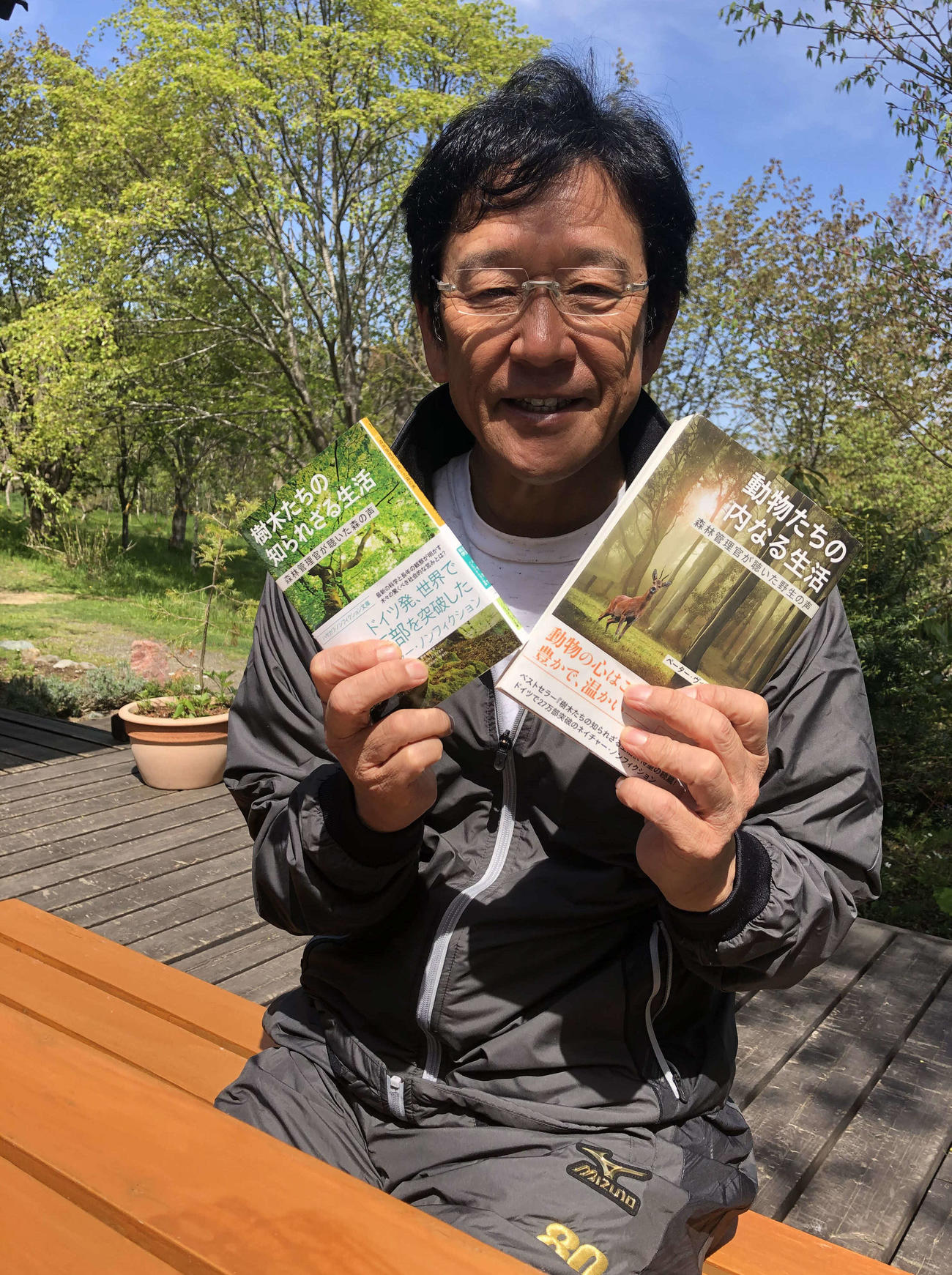 栗山町の「栗の樹ファーム」でオンライン取材を受け、オススメ本を紹介する日本ハム栗山監督（球団提供）