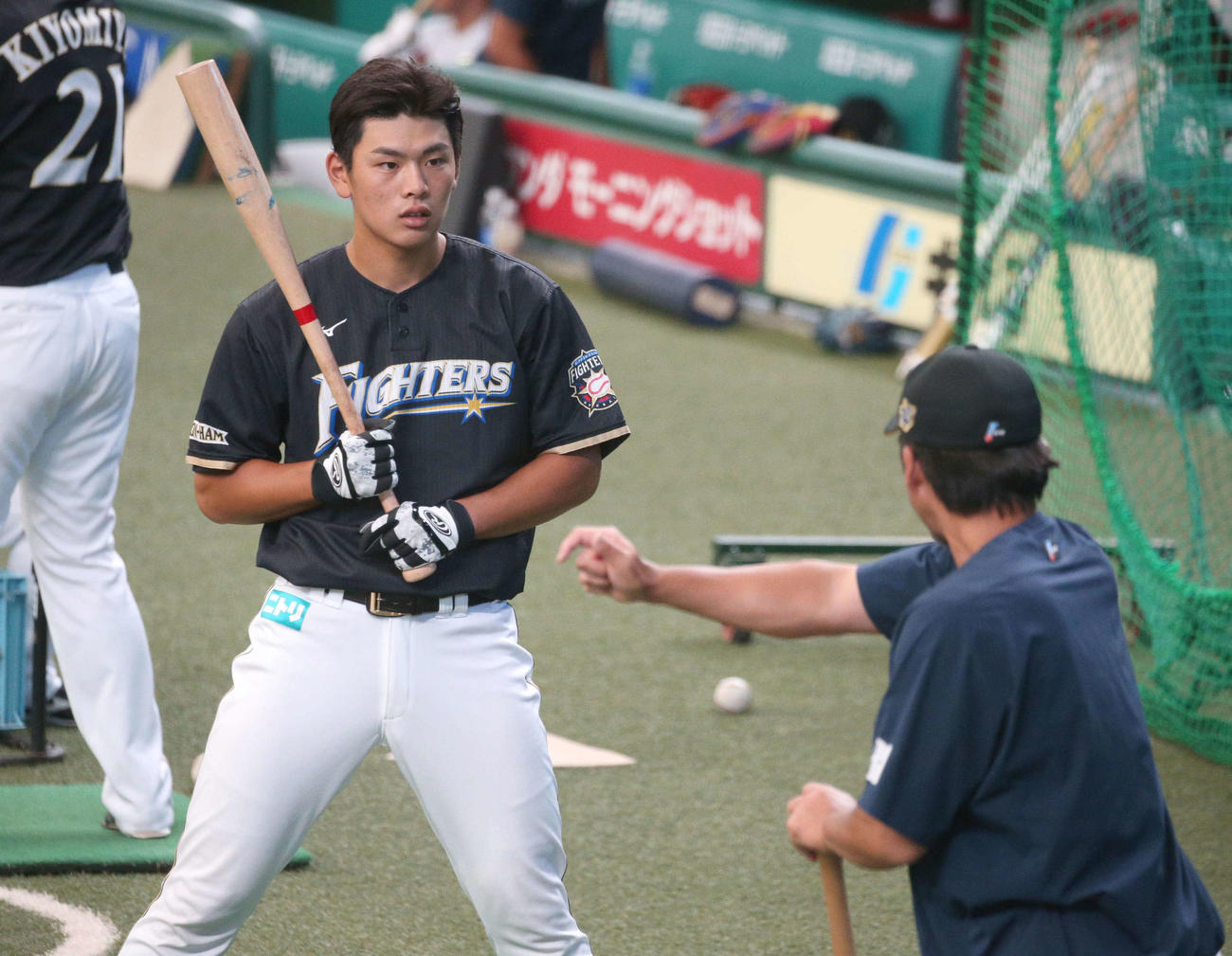 小笠原ヘッド兼打撃コーチ（右）に指導される野村（撮影・黒川智章）