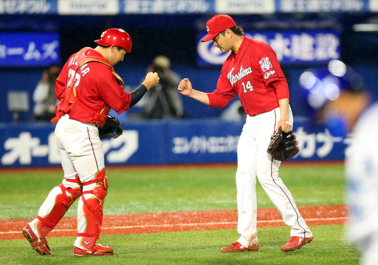 9回裏DeNA2死一、二塁、ロペスを遊ゴロに仕留めて、勝利した大瀬良（右）は会沢とエアグータッチをする（撮影・大野祥一）
