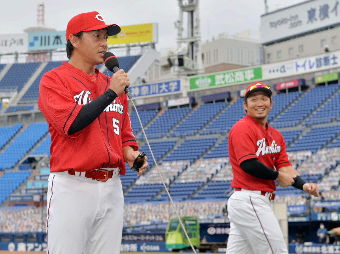 DeNA対広島　試合後、ヒーローインタビューを受ける広島長野（手前）を笑顔で見つめる鈴木誠（撮影・滝沢徹郎）