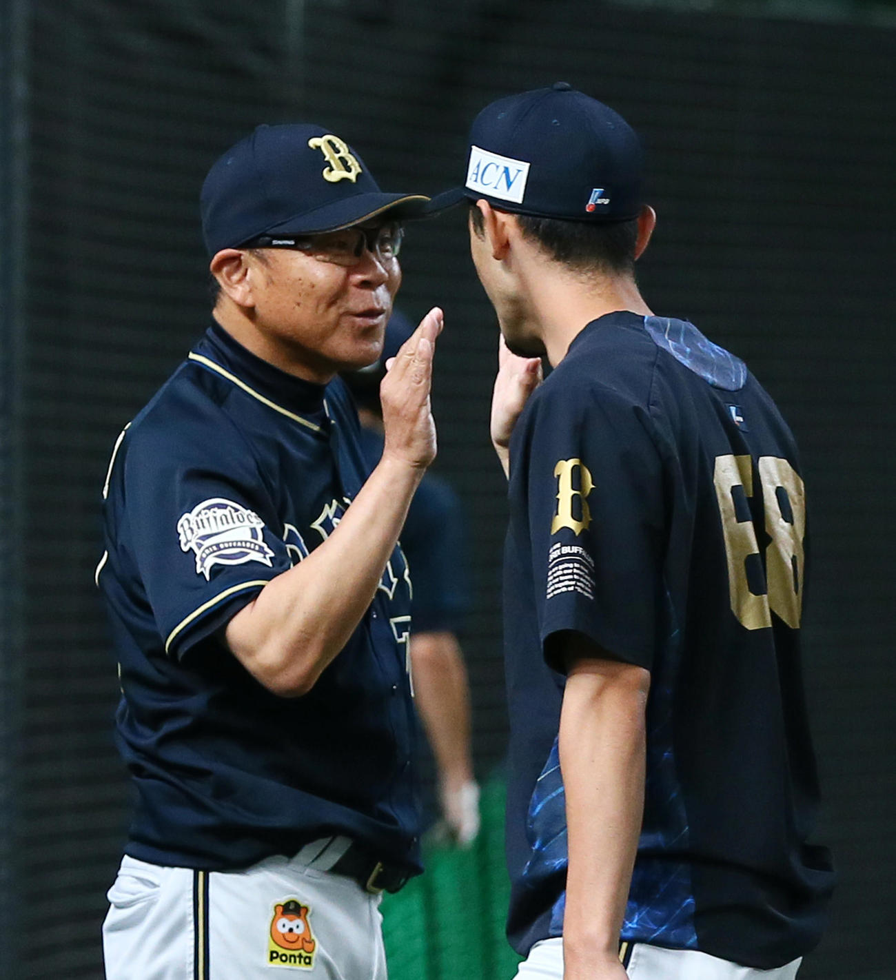 西武対オリックス　プロ初勝利球のオリックス鈴木（右）を笑顔で迎える西村監督（撮影・足立雅史）
