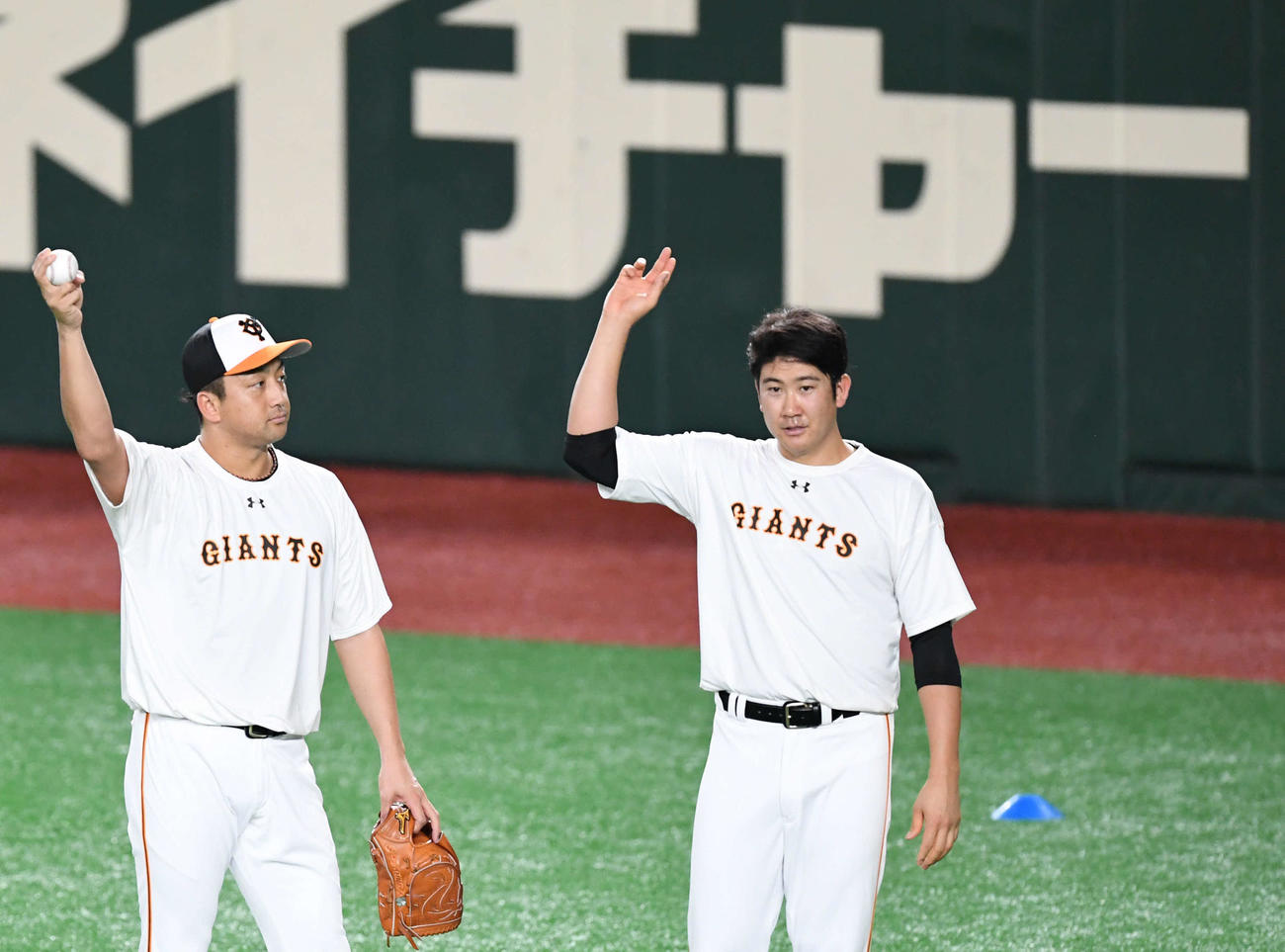 巨人対中日　試合前の練習で変化球の握りに着いて話し込む巨人沢村（左）と菅野（撮影・山崎安昭）