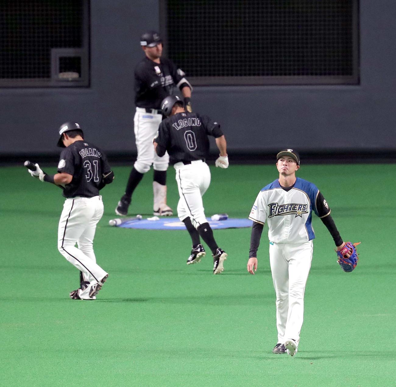 日本ハム対ロッテ　3回表ロッテ1死一、二塁、日本ハム清水の悪送球で追加点を許し悔しそうな表情を見せる日本ハム上沢（右手前）（撮影・佐藤翔太）
