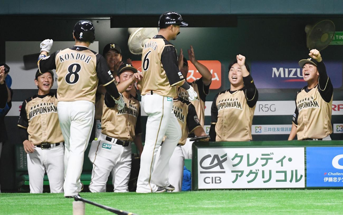 ソフトバンク対日本ハム　7回表日本ハム2死一、三塁、中田（手前中央）は左越えに勝ち越しの3点本塁打を放ち、栗山監督（左端）らナインに迎えられる（撮影・今浪浩三）
