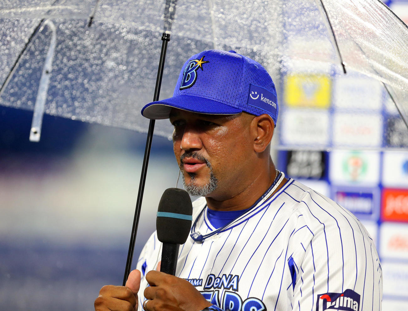 DeNA対広島　試合に敗れ、傘を差しながらインタビューに答えるDeNAラミレス監督（撮影・大野祥一）
