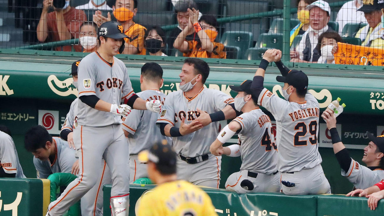 阪神対巨人　3回表巨人1死、中越え本塁打の北村（左）をゆりかごポーズで迎えるパーラ（中央）ら巨人ナイン（撮影・加藤哉）