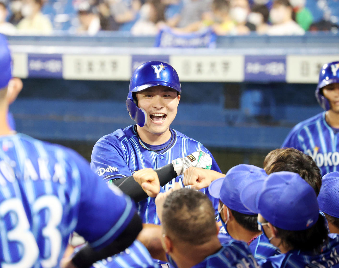 5回表DｅNA2死二塁、2点本塁打を放ち、ベンチのチームメートと喜び合う佐野（中央）（撮影・狩俣裕三）