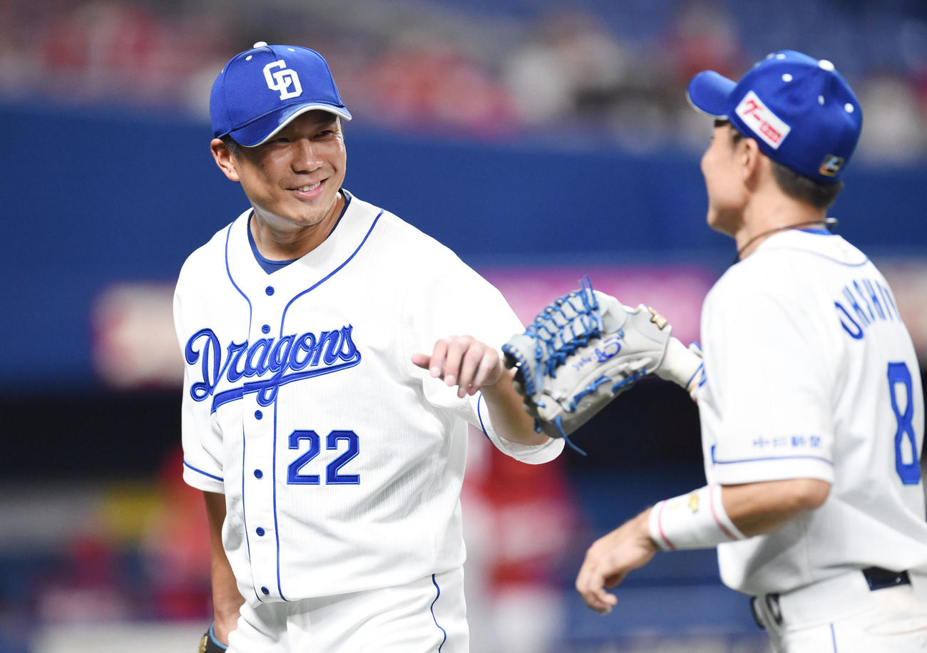 大島洋平（右）と笑顔でタッチを交わす中日先発の大野雄大（左）（撮影・森本幸一）
