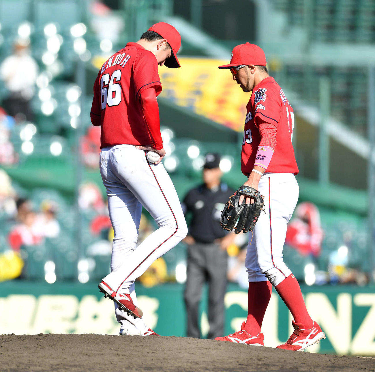 阪神対広島16回戦　5回裏阪神2死一、三塁、足を治療するも状態が良くならず降板となり、マウンドでうつむく遠藤淳志（右は菊池涼介）（撮影・岩下翔太）