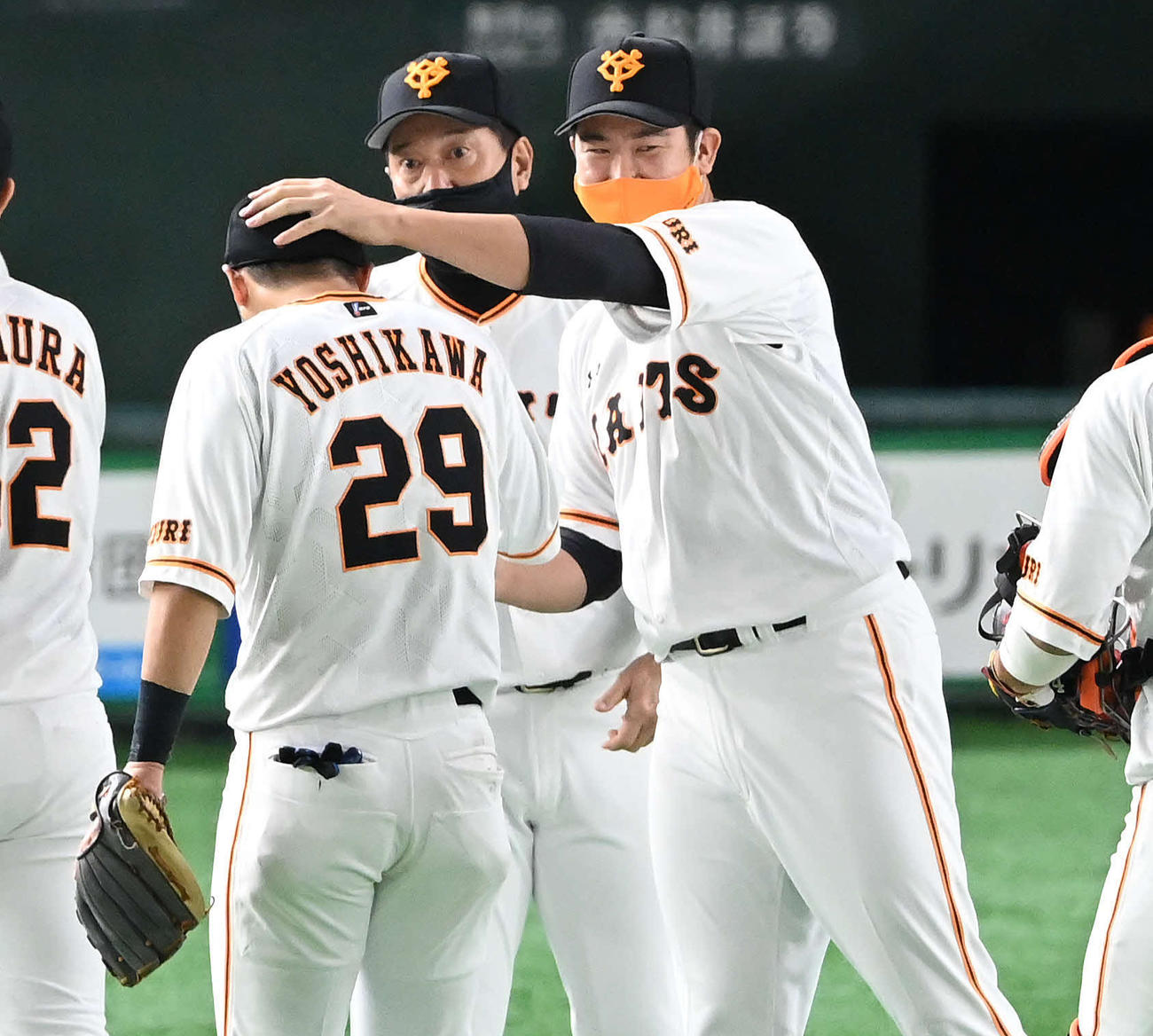 巨人対阪神　開幕11連勝の巨人菅野（右）は9回に好守をみせた吉川尚（左）の頭をなでる。中央は原監督（撮影・鈴木みどり）