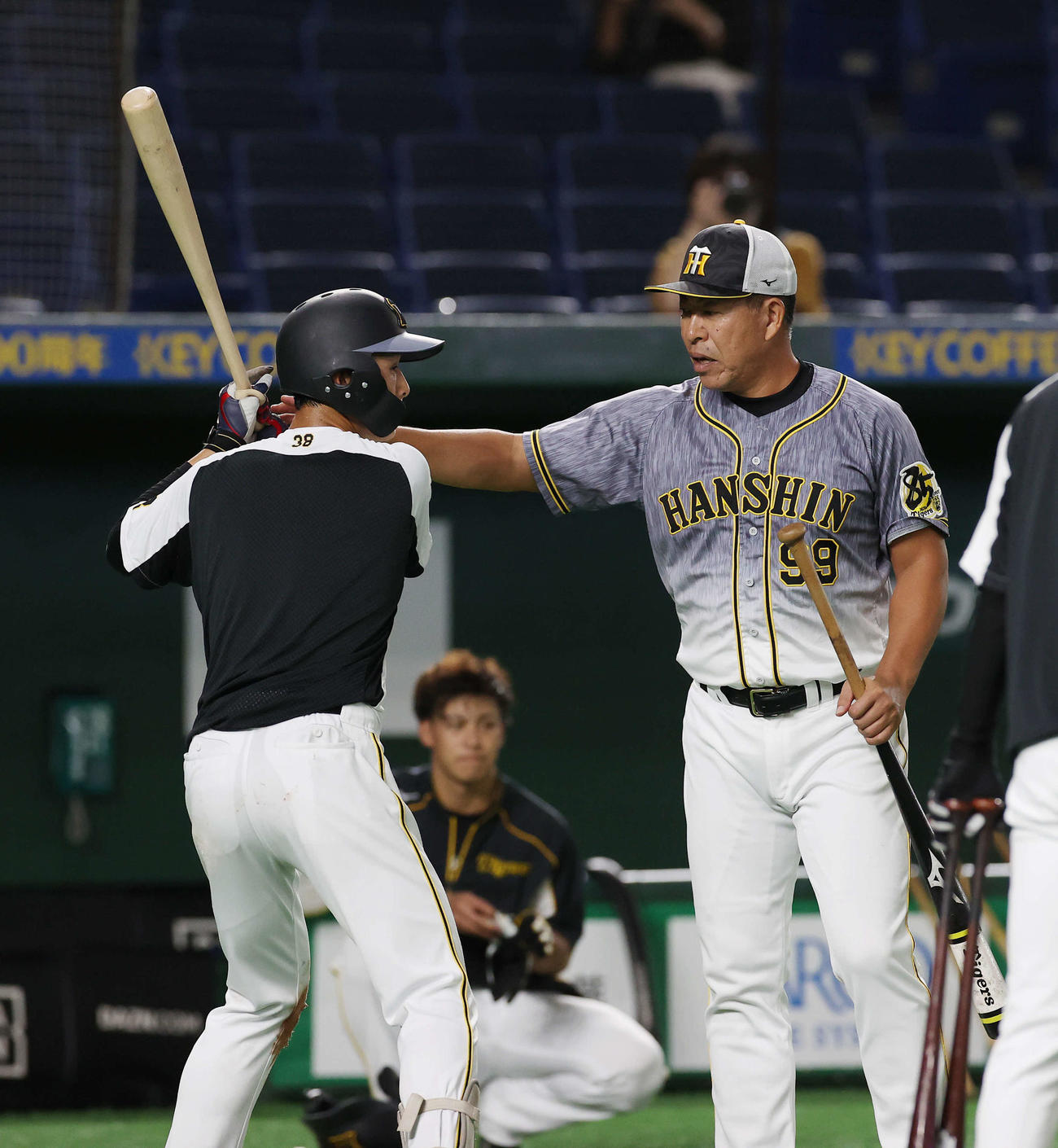 巨人対阪神　試合前練習で阪神井上打撃コーチ（右）の指導を受ける小幡（撮影・河野匠）