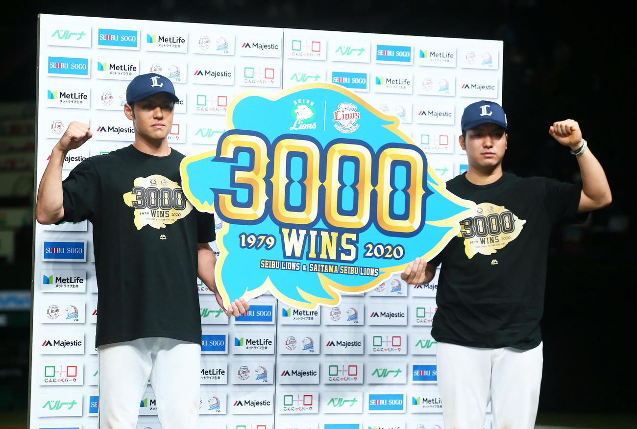西武対日本ハム　埼玉移転後、球団通算3000勝を達成し記念のボードを手にお立ち台でポーズを決める西武の木村（左）と柘植（撮影・足立雅史）