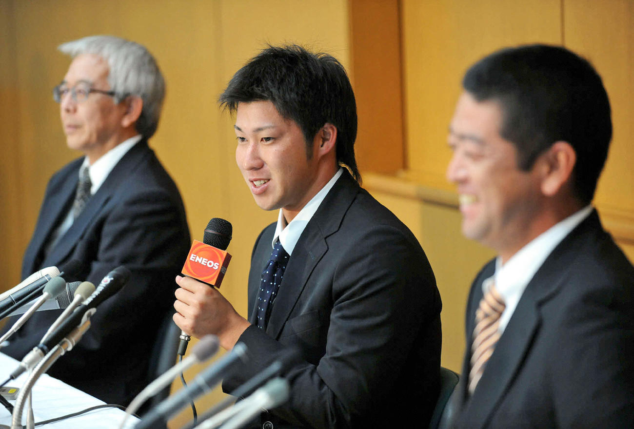 記者会見でメジャー挑戦を表明する新日本石油ENEOS・田沢純一（中央）、左は山縣由起夫野球部長、右は大久保秀昭監督（2008年9月11日撮影）