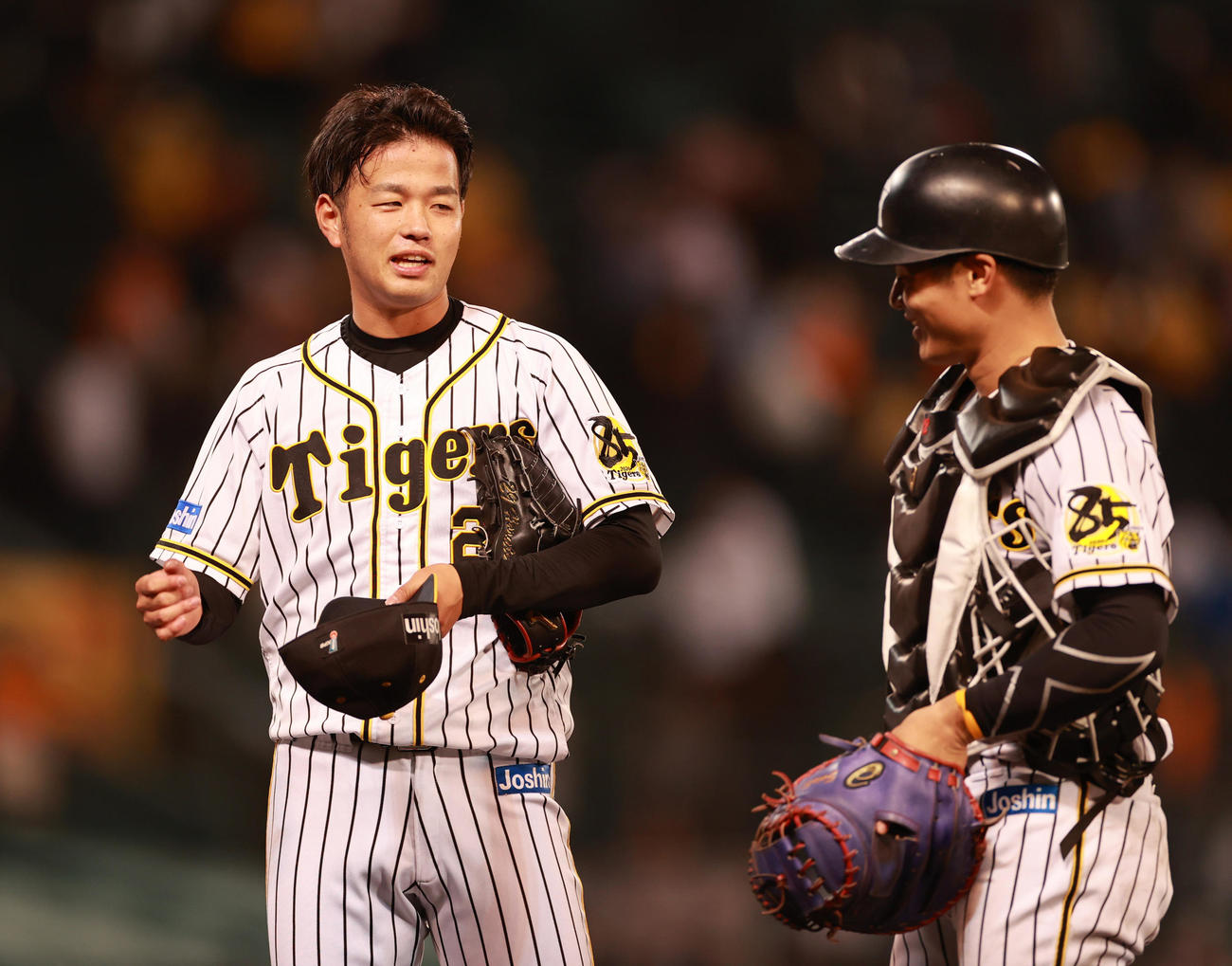 阪神対巨人　完投勝利をあげ捕手坂本（右）と笑顔で話す高橋（撮影・清水貴仁）