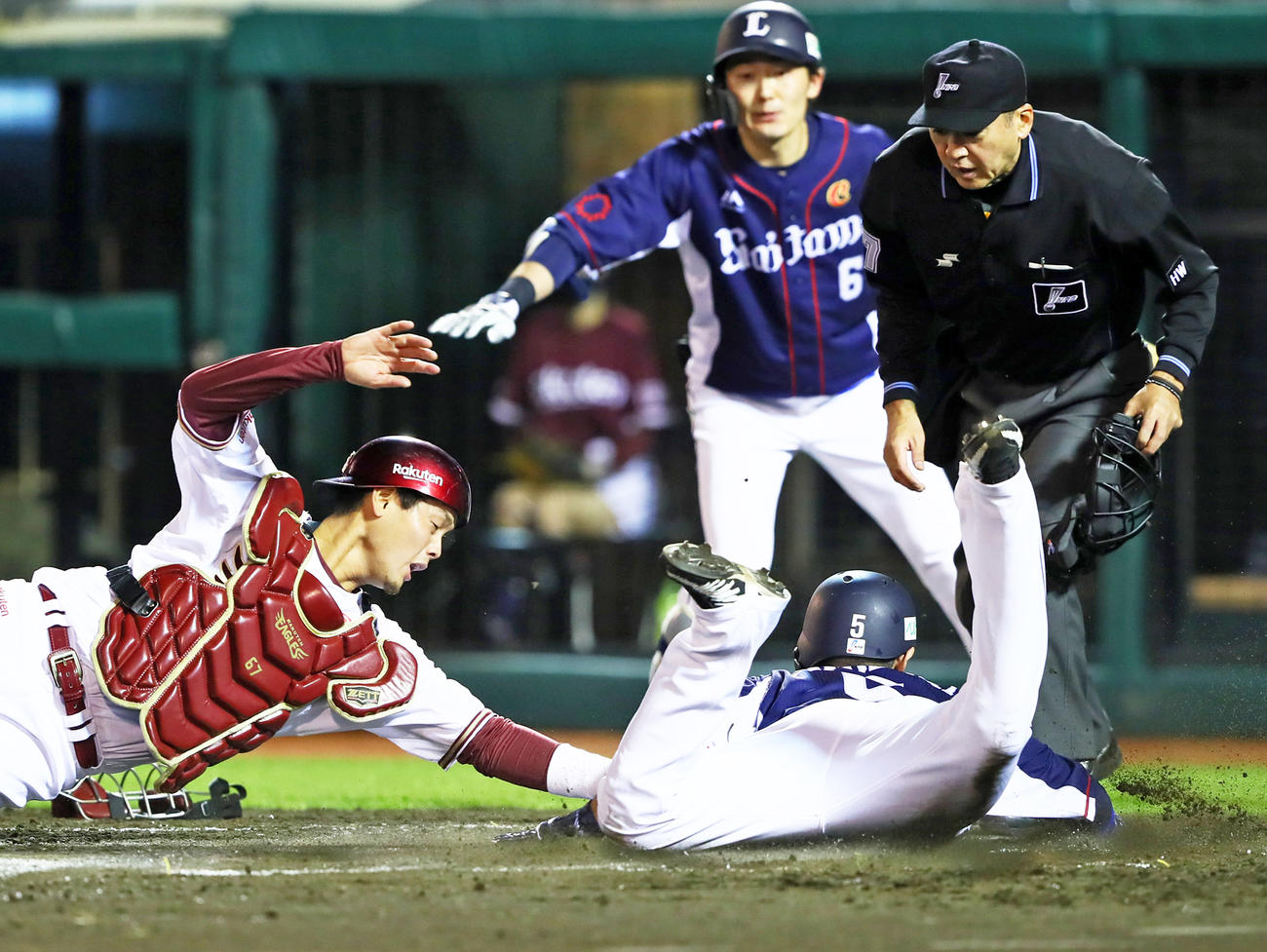 2回表西武2死一、二塁、金子の右前適時打で生還する外崎（右下）。捕手下妻（撮影・足立雅史）