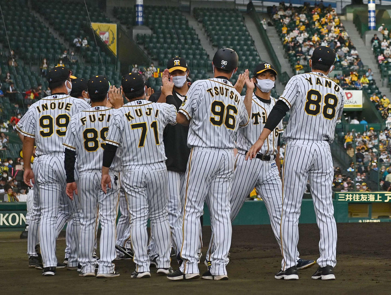 復帰後、初ホールドを記録した桑原（右から2人目）は矢野監督とエアタッチする（撮影・上田博志）