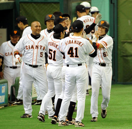5回裏巨人無死満塁、坂本勇人（右端）は満塁本塁打を放ち生還、ベンチ前でナインの出迎えに笑顔を見せる（2008年4月6日撮影）