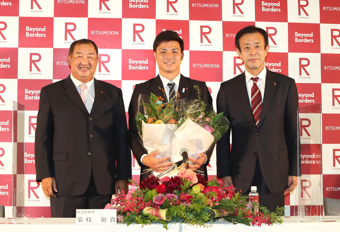 阪神から4位指名を受けて記念撮影に納まる左から立命館、後藤昇監督、栄枝裕貴、本郷真紹部長（撮影・白石智彦）