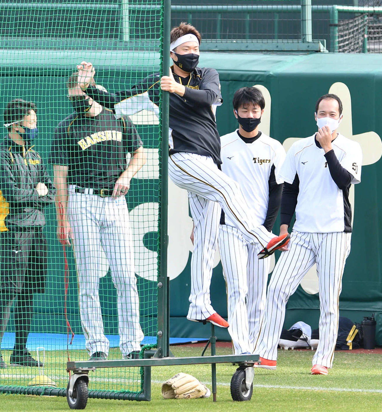 防球ネットのくいの上でバランスをとる西勇輝（撮影・岩下翔太）
