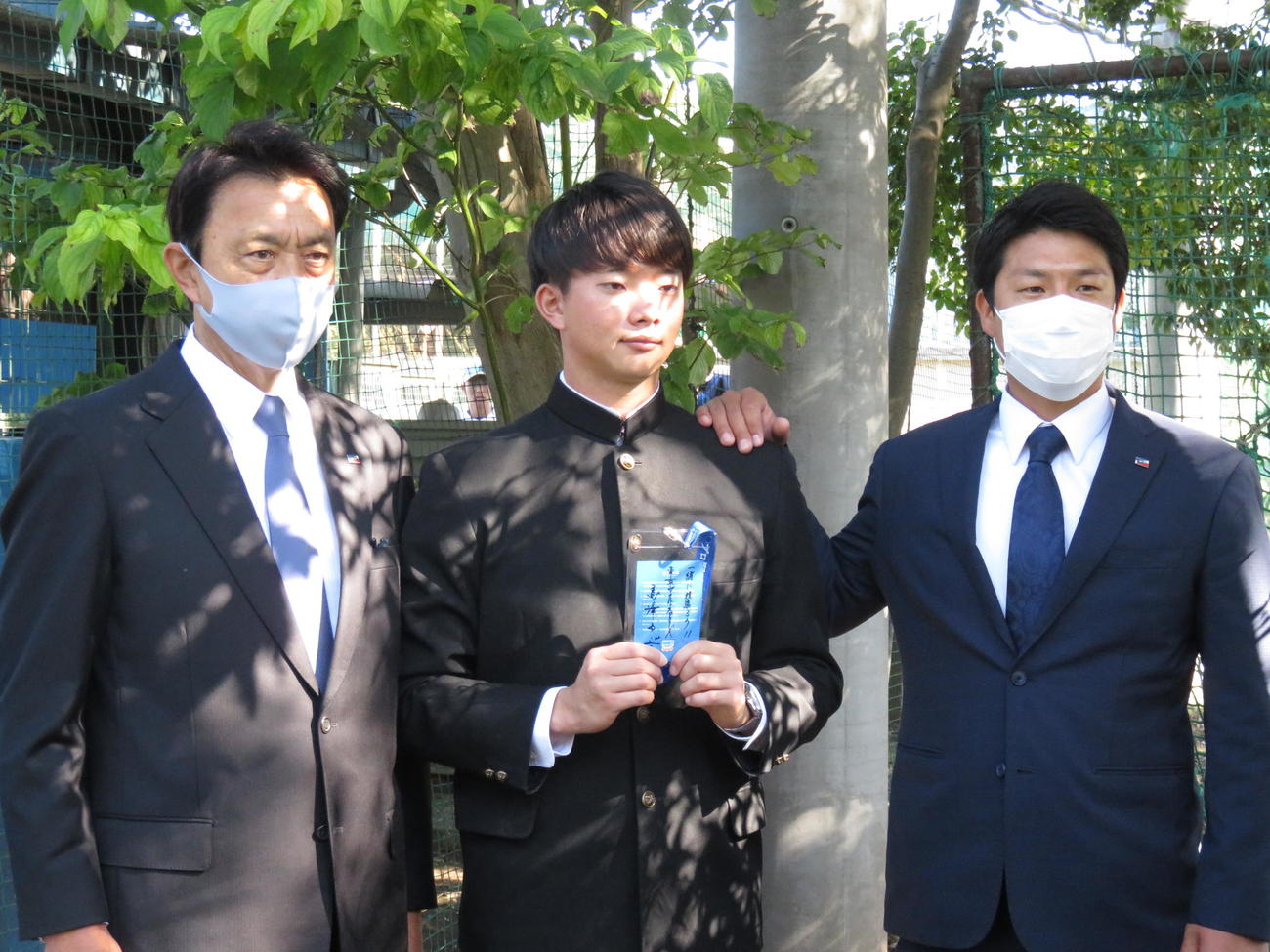 ヤクルトのドラフト1位、慶大・木沢尚文投手（22＝中央）が指名あいさつを受けた。左が小川GM、右は山本担当スカウト