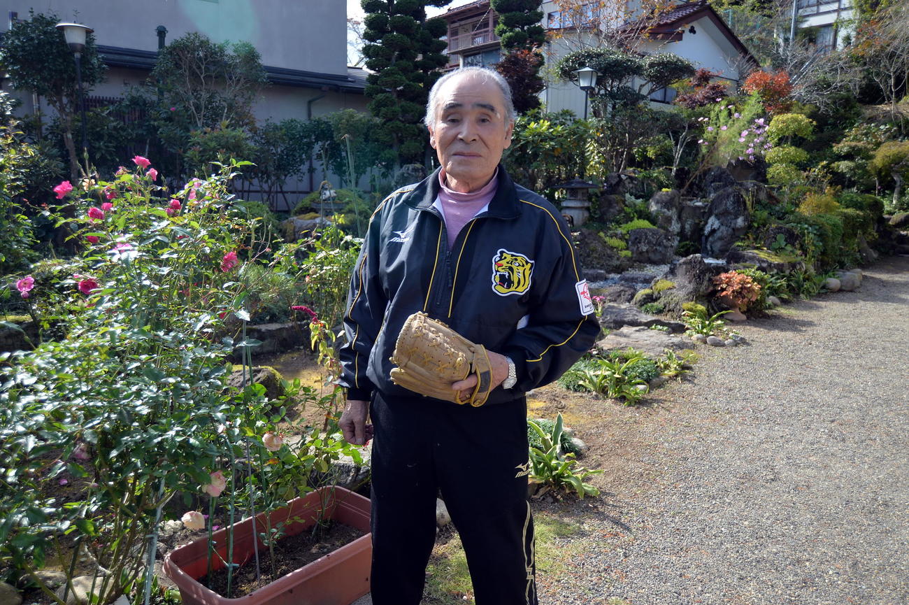 阪神ドラフト1位佐藤の父博信さんが小学校時代に愛用したグラブを手にする勲さん（撮影・中島正好）