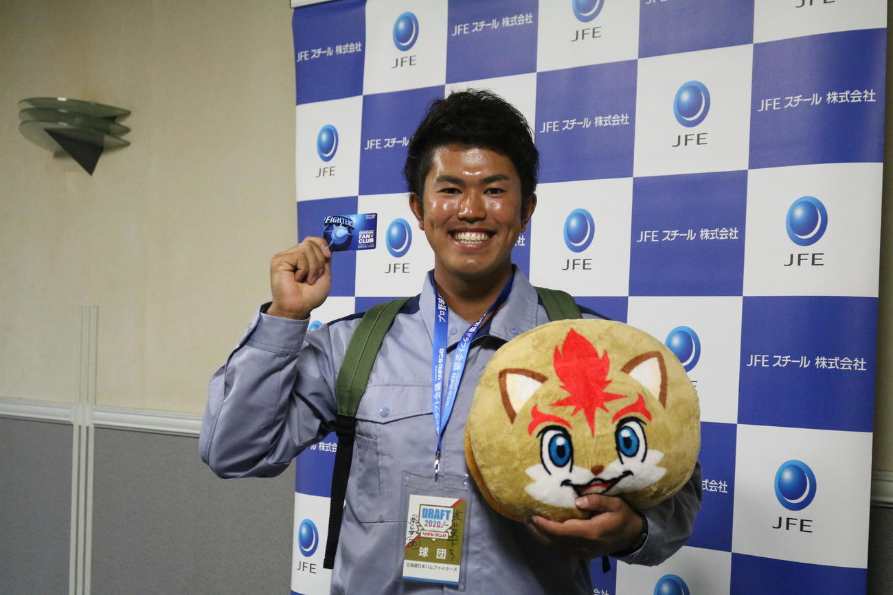日本ハムのファンクラブ会員限定グッズを手に満面の笑みを見せるドラフト6位JFE東日本・今川（撮影・田中彩友美）