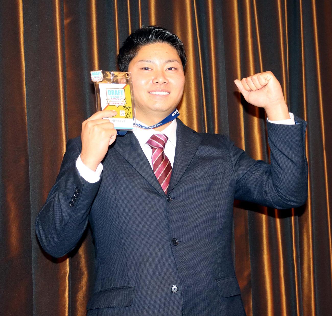 中日・与田監督のサインが入ったドラフト会議用パスを手にガッツポーズの札幌学院大の近藤投手（撮影・永野高輔）